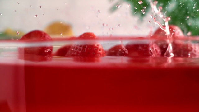 Video Reference N1: Red, Pink, Strawberry juice, Drink, Liquid, Pomegranate juice, Punch, Macro photography, Smoothie, Indoor, Sitting, Food, White, Rain, Small, Water, Table, Close, Blurry, Room, Display, Soft drink, Drop