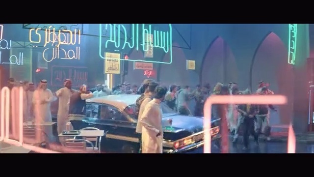 Video Reference N1: Fun, Music, Scene, Performance, Stage, Song, Fictional character, Crowd, Person, Man, Standing, Photo, Front, Sign, Bus, Woman, Table, Young, People, Girl, Holding, Street, Group, Restaurant, Playing, Display, Riding, Room, Text, Vehicle, Car, Land vehicle, Clothing