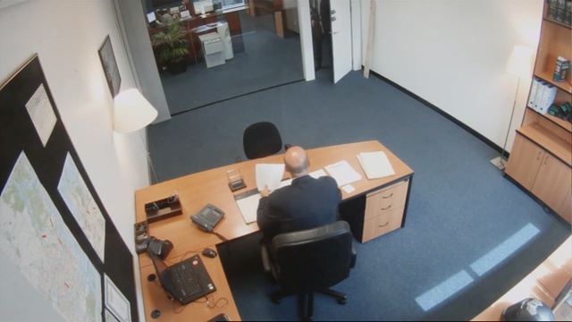Video Reference N2: Office, Desk, Room, Floor, Furniture, Flooring, Building, Office chair, Interior design, Table, Person