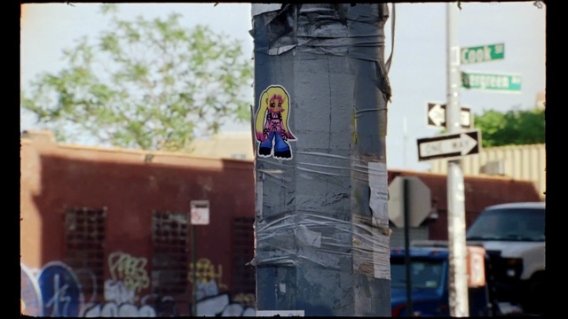 Video Reference N6: Street art, Wall, Art, Urban area, Advertising, Neighbourhood, Facade, Mural, Metropolitan area, Tree, Building, Outdoor, Sitting, Bus, Front, Food, Table, Street, Man, City, Standing, Woman, Large, White, Red, Riding, People, Window, Umbrella, Parked, Kitchen, Train, Text, Statue, Painting