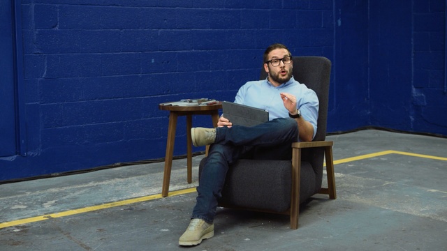 Video Reference N0: blue, sitting, man, furniture, male, chair, standing, table, fun, Person