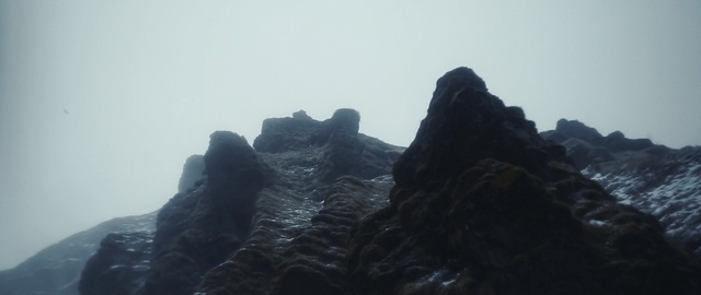 Video Reference N0: rock, mountainous landforms, mountain, sky, ridge, mountain range, formation, fog, landscape, mist