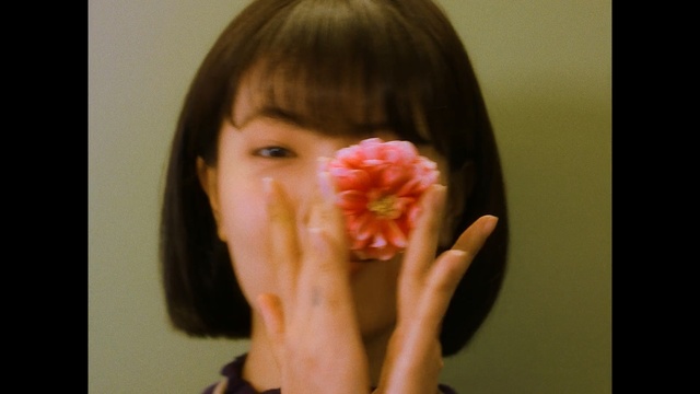 Video Reference N0: cheek, nose, chin, lip, finger, girl, hand, ear, mouth, flower