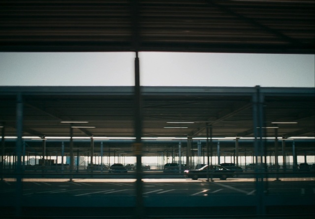 Video Reference N1: Sky, Architecture, Line, Urban area, Iron, Glass, Building, Reflection, Cloud, Metal, Fence, Window, Sitting, Standing, Track, Train, Man, Dark, Riding, Runway, Large, Woman, Light, Green, Night, White, People, Bridge, Street, Air, Airplane, Bus, Clock, Plane, Airport