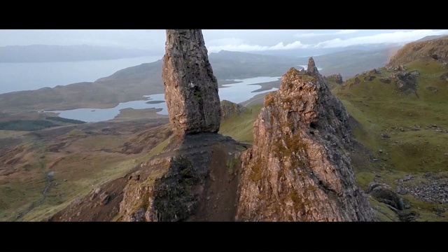 Video Reference N4: highland, rock, mountain, escarpment, sky, hill, terrain, cliff, ridge, fell
