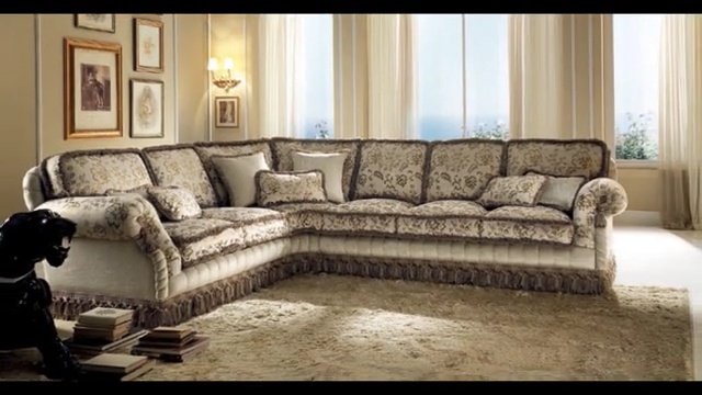 Video Reference N1: furniture, couch, living room, loveseat, room, home, interior design, sofa bed, angle, recliner, Person