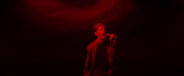 Video Reference N16: Red, Black, Performance, Entertainment, Darkness, Maroon, Light, Performing arts, Microphone, Music, Person