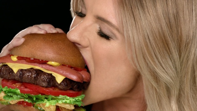 Video Reference N2: fast food, hamburger, junk food, food, sandwich, eating, mouth, cheeseburger, lip, veggie burger, eating
