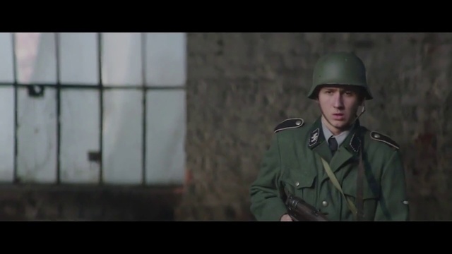 Video Reference N1: Soldier, Military, Military person, Military uniform, Army, Movie, Uniform, Headgear, Infantry, Action film, Person, Building, Clothing, Green, Man, Standing, Wearing, Holding, Looking, Suit, Front, Hat, Helmet, Woman, Young, Room, Glass, White, Phone, Train, Screenshot, Human face, Fashion accessory, Fedora, Video game