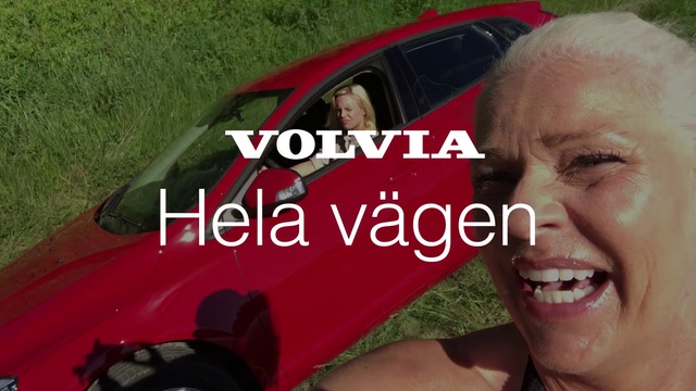 Video Reference N7: Vehicle door, Vehicle, Car, Driving, Automotive exterior, Font, Automotive window part, Photo caption, Photography, Compact car, Person, Grass, Outdoor, Woman, Red, Holding, Smiling, Man, Wearing, Face, Lady, Posing, Sitting, Young, Glasses, Black, Close, Sign, Girl, Standing, Umbrella, White, Phone, Land vehicle, Human face