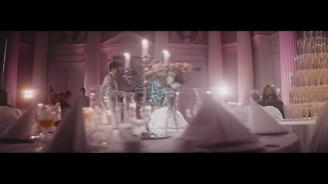 Video Reference N0: Photograph, Dress, Snapshot, Stage, Function hall, Fashion, Pink, Performance, Photography, Event, Table, Indoor, Glasses, Lit, Sitting, Photo, Wine, Man, Front, Different, White, Several, Woman, Light, Room, Large, Many, Cake, Curtain, People, Candle, Wedding dress, Wedding, Bride, Wedding cake, Dining table