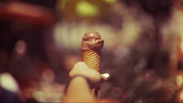Video Reference N3: Macro photography, Ice cream cone, Microphone, Photography, Sitting, Food, Table, Man, Dessert, Ice cream, Fast food, Chocolate, Abstract, Blur