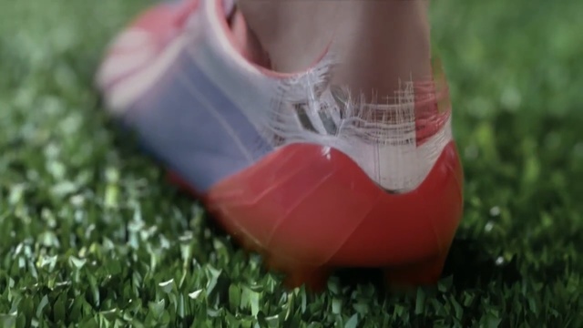 Video Reference N0: Grass, Footwear, Red, Shoe, Leg, Lawn, Human leg, Close-up, Soccer ball, Foot