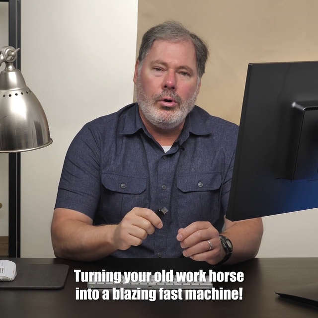 Video Reference N1: Arm, Chin, Facial hair, Muscle, Finger, Hand, Photography, Gesture, Sconce, Photo caption, Person, Indoor, Man, Table, Sitting, Holding, Computer, Front, Black, Desk, Smiling, Laptop, Posing, Woman, Large, Food, Keyboard, Standing, Sign, Wall, Text, Human face, Clothing