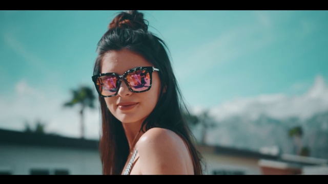 Video Reference N1: Eyewear, Hair, Sunglasses, Glasses, Photograph, Face, Cool, Black hair, Beauty, Lip, Person, Woman, Looking, Wearing, Holding, Front, Lady, Photo, Smiling, Standing, Sun, Posing, Young, Water, Red, Phone, Laptop, Girl, White, Table, Computer, Man, Keyboard, Shirt, Blue, Sky, Human face, Goggles, Clothing, Smile, Swimwear, Brassiere, Fashion accessory, Beach, Surfer hair, Long hair, Brown hair, Beautiful, Spectacles, Staring