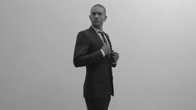 Video Reference N0: White, Standing, Black, Gentleman, Suit, Male, Black-and-white, Photography, Monochrome, Gesture, Person, Man, Outdoor, Looking, Front, Holding, Photo, Woman, Wearing, Young, Dress, Water, Dressed, Phone, Sign, Beach, Shirt, Field, Suitcase, Snow, Flying, Kite, Clothing, Fog, Human face, Tie, Coat