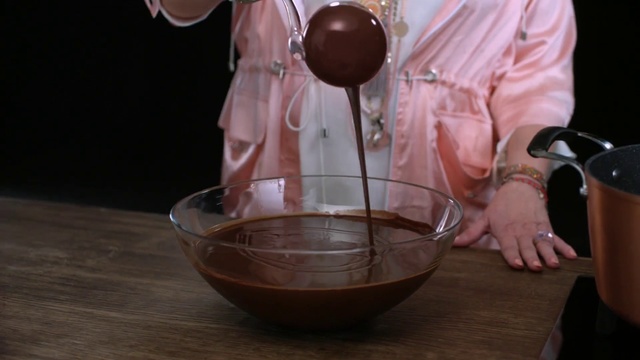 Video Reference N0: Chocolate, Food, Table, Person, Indoor, Wine, Sitting, Cup, Wooden, Front, Glasses, Man, Glass, Holding, Bowl, Woman, Kitchen, Standing, Red, Plate, Tableware