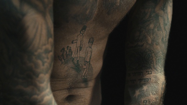 Video Reference N9: tattoo, arm, hand, joint, darkness, close up, human, tree, muscle, flesh