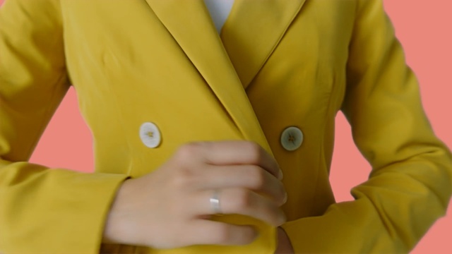 Video Reference N0: Yellow, Outerwear, Jacket, Blazer, Suit, Button, Formal wear, Hand, Coat, Top, Person, Clothing, Wearing, Man, Holding, Boy, Looking, Young, Sitting, Shirt, Table, Glasses, Woman, Phone, Trouser