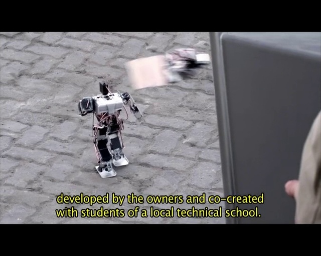 Video Reference N1: Robot, Photo caption, Machine, Technology, Font, Photography, Fictional character
