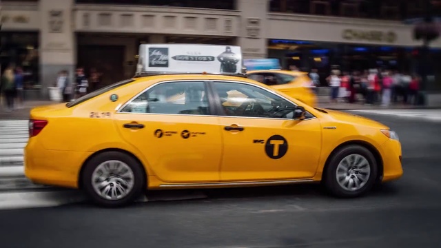 Video Reference N6: Taxi, Vehicle, Car, Yellow, Motor vehicle, Transport, Mid-size car, Sedan, Compact car, Sports sedan