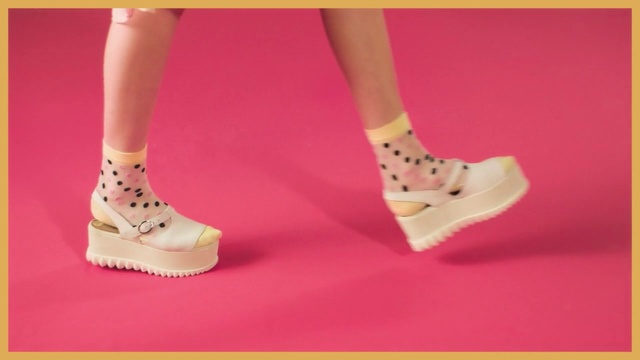 Video Reference N1: Footwear, Shoe, Pink, Human leg, Ankle, Joint, Leg, Beige, High heels, Foot, Person, Woman, Yellow, Holding, Racket, Standing, Dress, Female, Girl, Red, Table, Young, Player, Ball, White, Court, Room, Playing, Man, Blue, Sandal, Boot, Sock, Basic pump, Toe, Bridal shoe, Fashion accessory, Ballet flat, Court shoe, Sneakers, Flip-flops, Heel