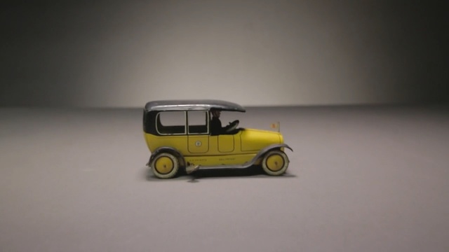 Video Reference N5: Land vehicle, Vehicle, Motor vehicle, Yellow, Car, Mode of transport, Model car, Vintage car, Automotive wheel system, Classic car, Person