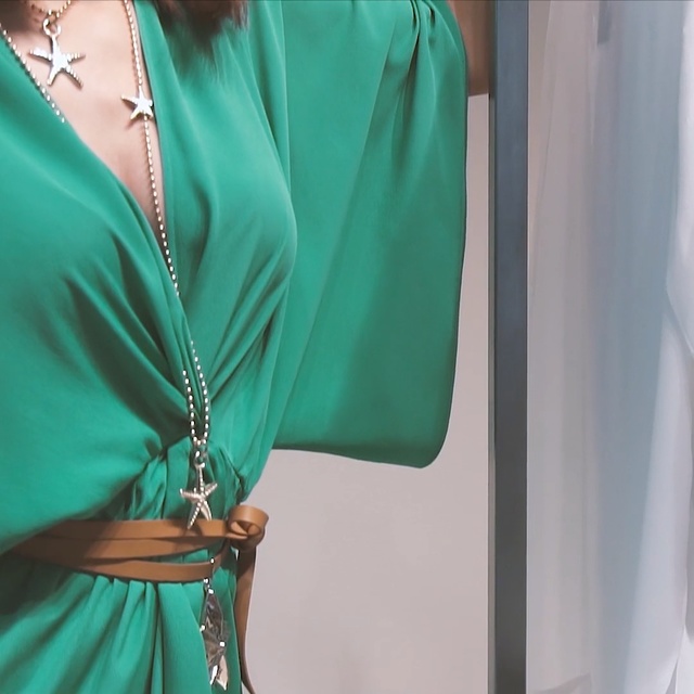 Video Reference N0: Green, Aqua, Clothing, Shoulder, Turquoise, Blue, Dress, Teal, Neck, Person, Woman, Lady, Standing, Cellphone, Phone, Holding, Wearing, Sitting, Shirt, Young, White, Man, Room, Wall, Fashion accessory, Necklace, Handbag, Blouse, Fashion