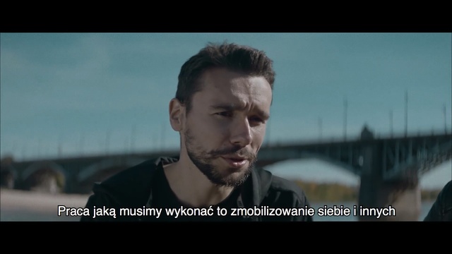 Video Reference N2: Movie, Human, Photo caption, Screenshot, Photography, Action film, Facial hair, Jaw, Beard, Moustache, Person, Man, Looking, Front, Water, Photo, Holding, Standing, Laptop, Screen, Sitting, Woman, Wearing, Glass, Computer, Table, Sign, White, Phone, Boat, Human face, Text, Clothing, Face, Portrait, Staring