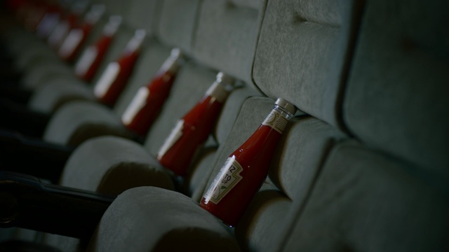 Video Reference N5: Bottle, Ketchup, close up, sits, Movie theater