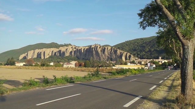 Video Reference N3: Road, Mountainous landforms, Thoroughfare, Asphalt, Natural landscape, Hill, Rock, Highway, Infrastructure, Geology