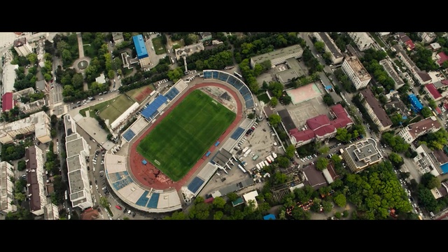 Video Reference N10: Aerial photography, Sport venue, Stadium, Bird-eye view, Urban area, Metropolitan area, Urban design, Residential area, Human settlement, Soccer-specific stadium, Person, Food, City, Aerial