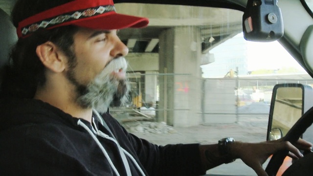 Video Reference N0: car, facial hair, beard, vehicle, automotive exterior, glass, driving, city car