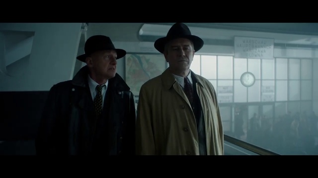 Video Reference N2: Gentleman, Movie, Male, Screenshot, Fedora, Photography, Suit, White-collar worker, Scene, Hat, Person, Man, Indoor, Standing, Front, Looking, Window, Table, Monitor, Holding, Wearing, Large, Screen, Kitchen, Wine, Food, Display, White, Room, Computer, Group, Shirt, People, Fashion accessory, Cowboy hat, Clothing, Human face, Sun hat, Text