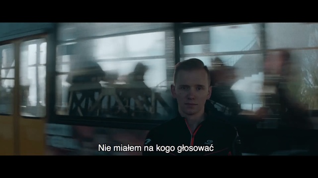 Video Reference N4: Snapshot, Display device, Movie, Mode of transport, Screenshot, Photography, Fun, Media, Action film, Muscle, Person, Window, Indoor, Bus, Man, Photo, Looking, Front, Television, Train, Holding, Standing, Sitting, Screen, Monitor, Room, Woman, Black, Large, Young, Riding, Human face, Text, Clothing