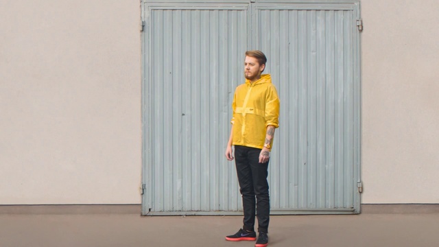 Video Reference N3: Yellow, Standing, Fashion, Orange, Shoulder, Outerwear, Denim, Footwear, Joint, Door, Person, Building, Young, Man, Front, Woman, Black, Boy, Shirt, Holding, Wearing, Girl, School, Riding, Playing, Room, Frisbee, White, Trousers, Clothing, Jeans, Jacket, Sleeve, Coat