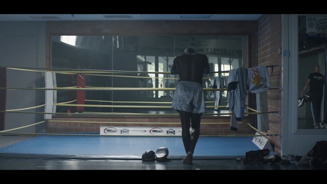 Video Reference N3: boxing ring, boxing equipment, sport venue, structure, boxing, pradal serey, darkness, screenshot, Person