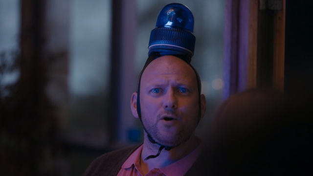 Video Reference N1: Face, Blue, Head, Light, Purple, Human, Forehead, Headgear, Photography, Electric blue, Person, Indoor, Man, Wearing, Looking, Table, Sitting, Front, Young, Shirt, Close, Standing, Food, Holding, Cake, White, Pink, Hat, Red, Room, Pizza, Human face, Fashion accessory, Clothing