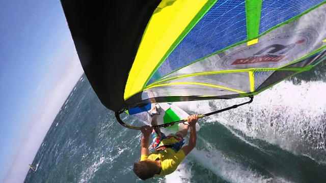 Video Reference N3: Windsurfing, Sail, Recreation, Outdoor recreation, Sailing, Vehicle, Surface water sports, Water sport, Boardsport, Wave, Water, Sport, Outdoor, Person, Yellow, Surfing, Riding, Man, Green, Young, Holding, Board, Small, Shirt, Wearing, Large, Suit, Boat, Ocean, Colorful, Doing, Standing, Air, White, Windsports, Paddle