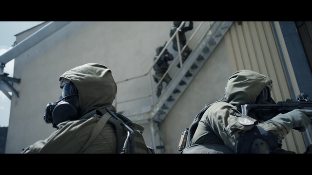 Video Reference N6: Personal protective equipment, Helmet, Headgear, Photography, Indoor, Person, Man, Riding, Room, Luggage, White, Table, Air, Doing, People, Clothing, Jacket, Human face, Weapon, Gun