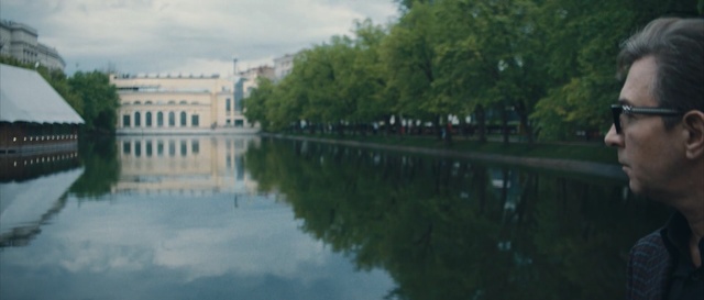 Video Reference N3: waterway, reflection, water, body of water, canal, river, sky, tree, reflecting pool, tourism, Person