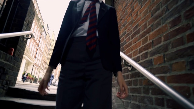 Video Reference N2: suit, standing, outerwear, formal wear, gentleman, building, street