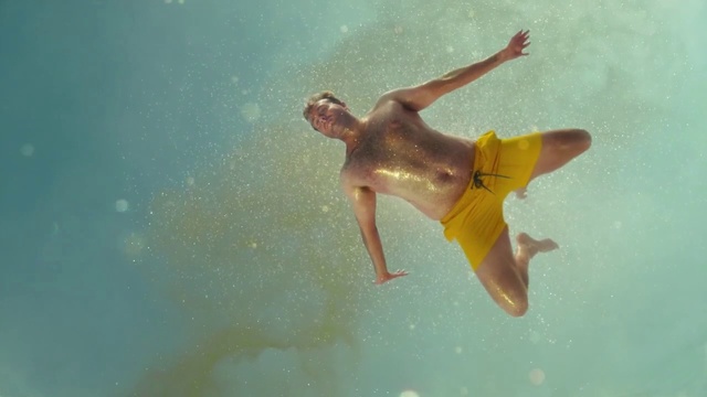 Video Reference N2: Underwater, Fun, Water, Organism, Recreation, Swimming, Vacation, Outdoor, Sport, Wave, Person, Board, Young, Surfing, Ocean, Man, Riding, Yellow, Boy, Air, Large, Throwing, Shirt, Jumping, Frisbee, Blue, Doing, Body, Trick, Holding, Catch, Swimwear, Water sport, Beach