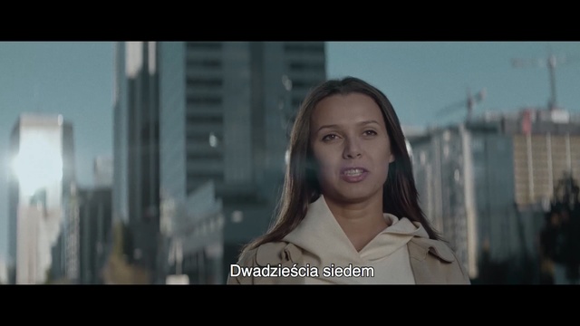 Video Reference N1: Face, Snapshot, Scene, Eye, Photography, Black hair, Screenshot, Happy, Photo caption, Long hair, Person, Woman, Building, Photo, Front, Holding, Girl, Smiling, Young, Standing, Table, White, Man, Shirt, Wearing, Sign, City, Human face, Portrait, Text, Clothing