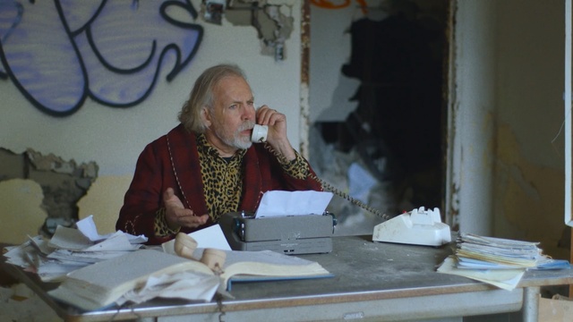 Video Reference N1: man, old man, office, graffiti, garbage, phone 