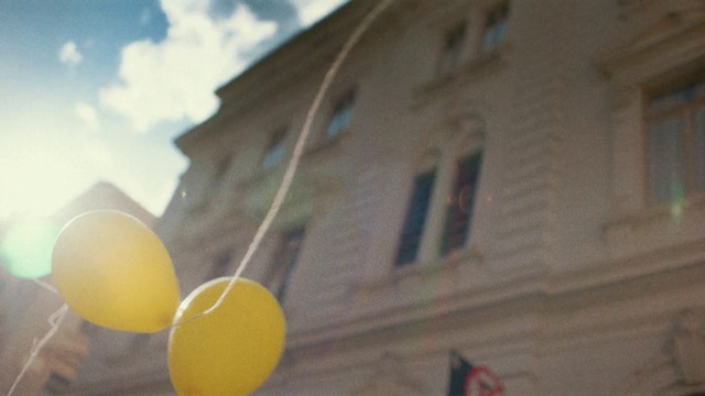 Video Reference N2: Yellow, Daytime, Balloon, Sky, Architecture, Street light, Smile, Facade