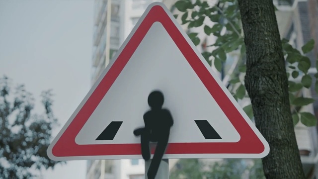 Video Reference N2: Sign, Traffic sign, Signage, Triangle, Street sign, Road, Pedestrian