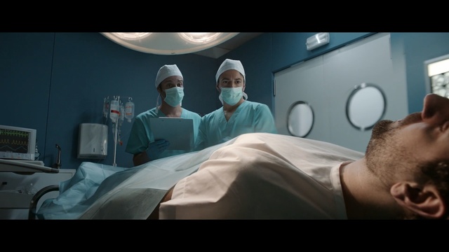 Video Reference N2: Medical procedure, Surgeon, Operating theater, Hospital, Medical, Room, Medical equipment, Service, Scrubs, Screenshot, Person