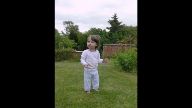 Video Reference N4: photograph, nature, child, white, people, clothing, standing, grass, green, facial expression, Person