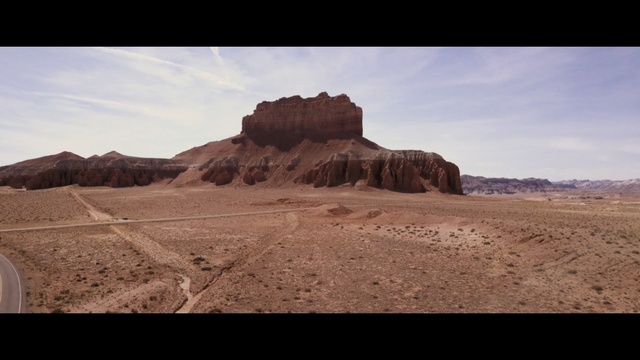 Video Reference N6: badlands, ecosystem, desert, sky, mountainous landforms, wilderness, rock, wadi, butte, historic site